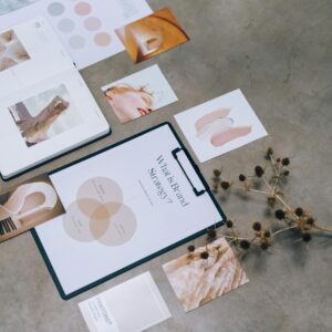 A modern flat lay of branding strategy documents and design elements on a desk.